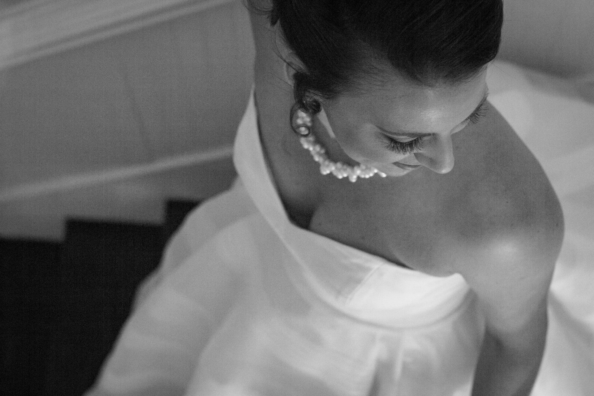 A woman in a wedding dress is sitting on a set of stairs.