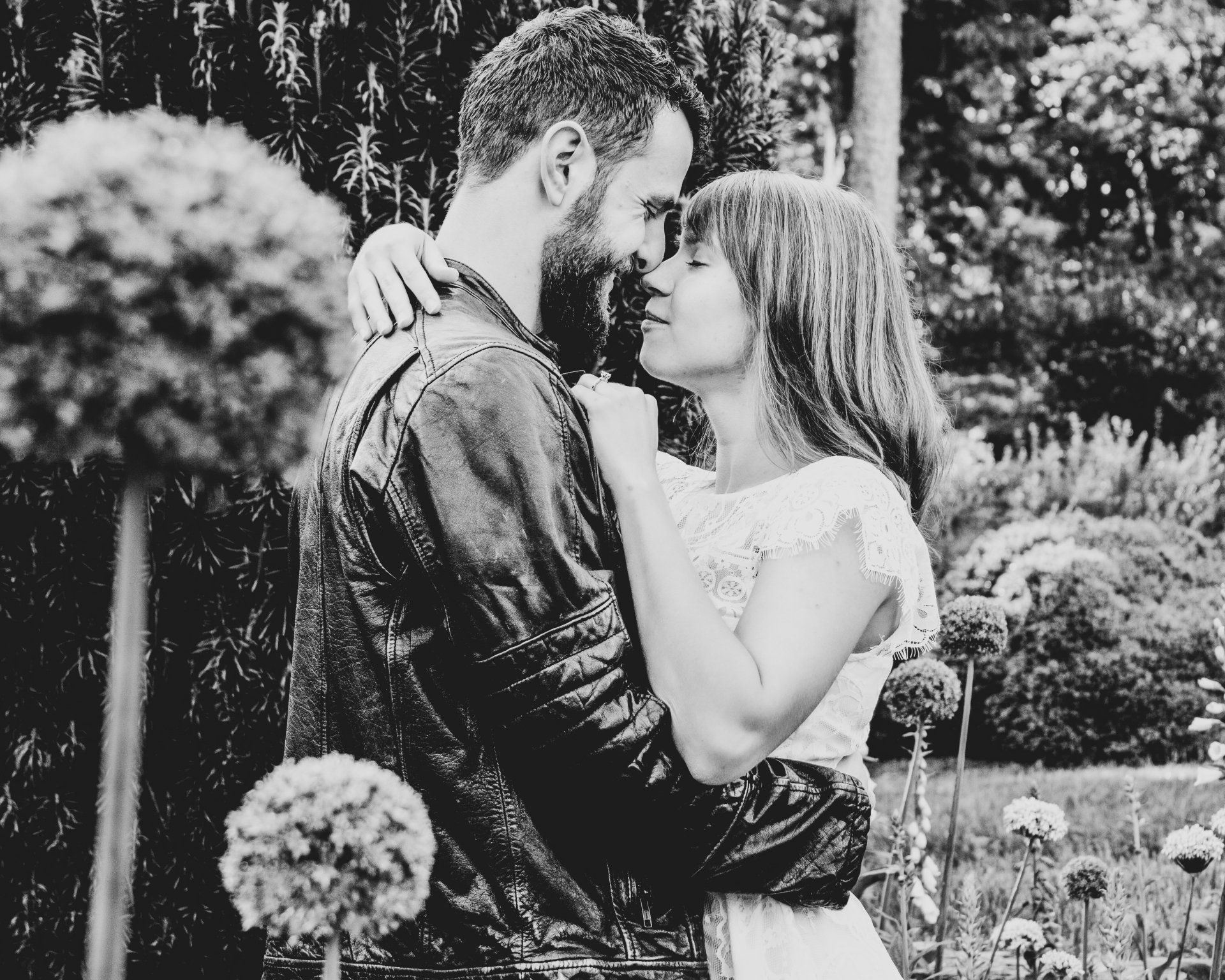 A black and white photo of a man and woman hugging each other.