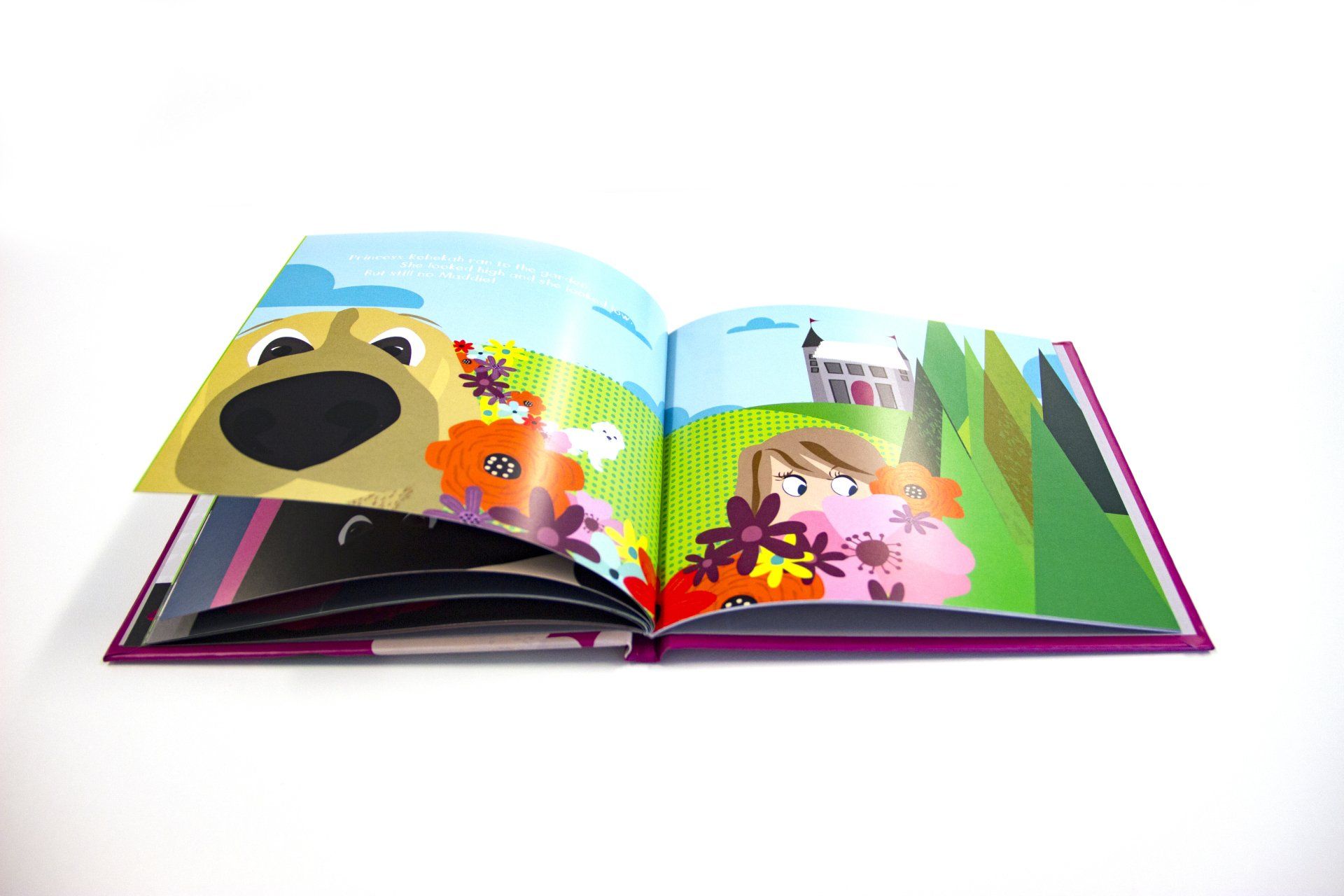 A book is open to a page with a dog and a girl.