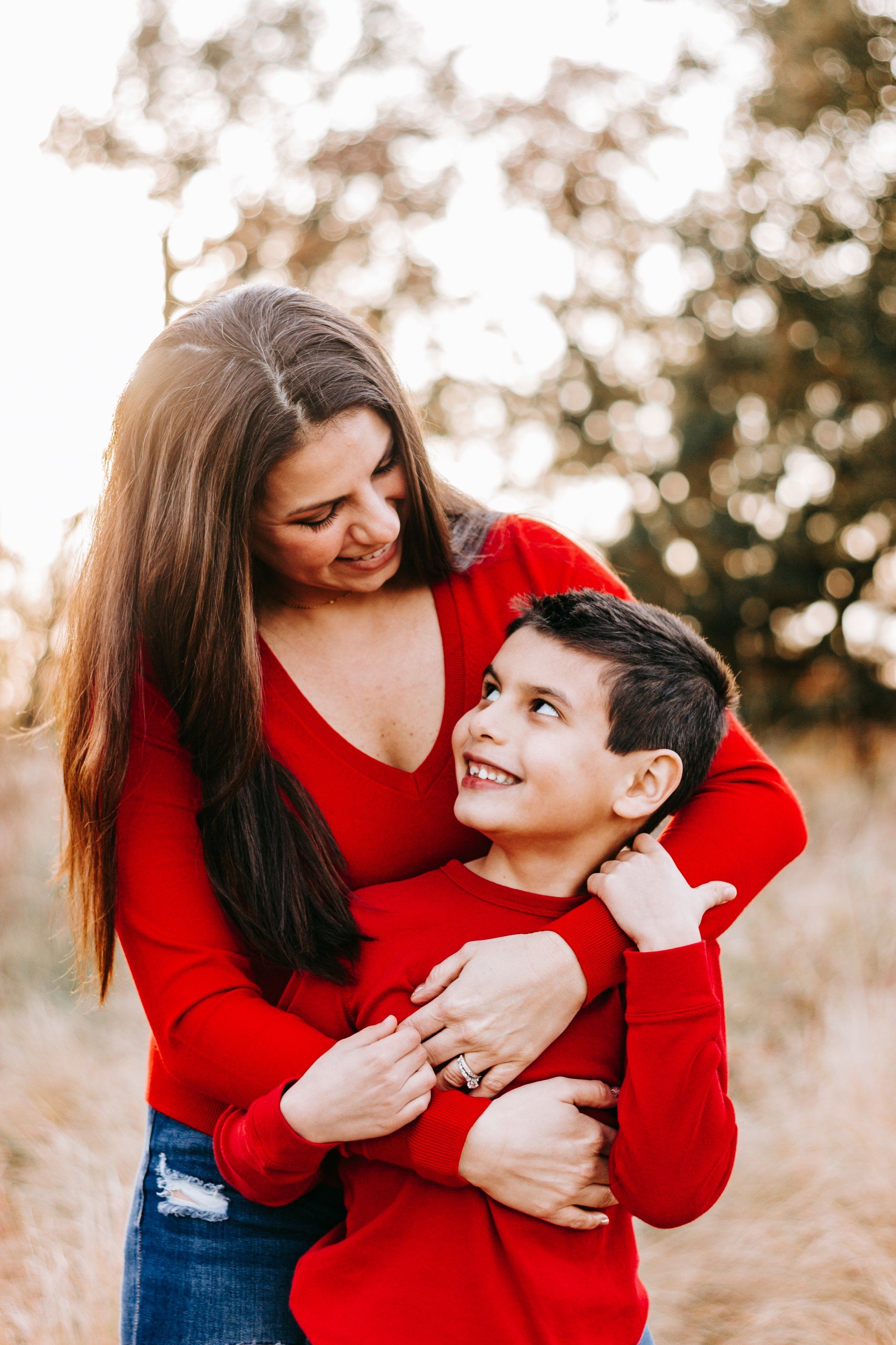 A woman is holding a young boy in her arms.