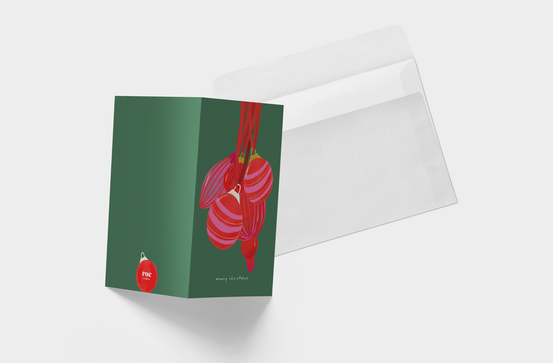 A christmas card with red and pink ornaments hanging from a red ribbon