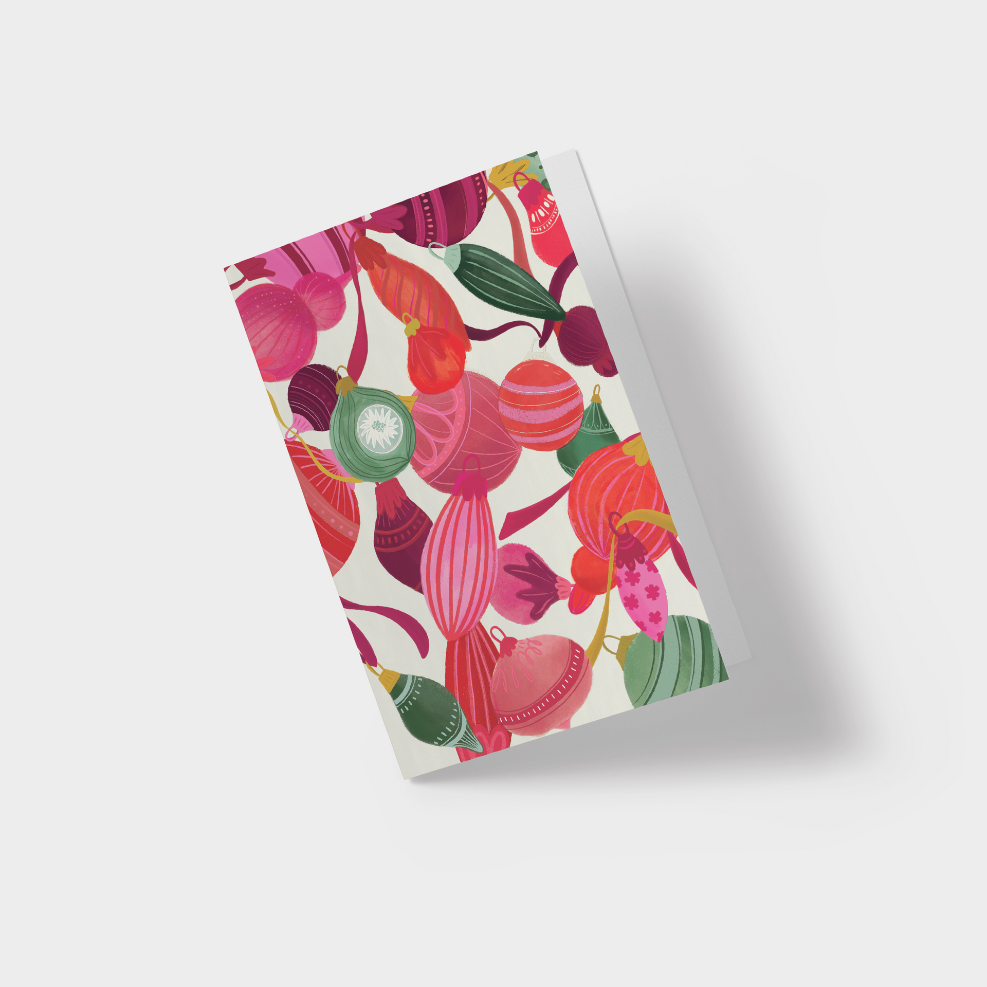 A red folder with a floral pattern on it and a white envelope.