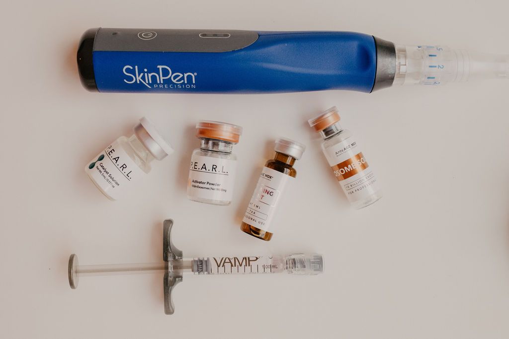 A woman is touching her face with her hand and smiling.