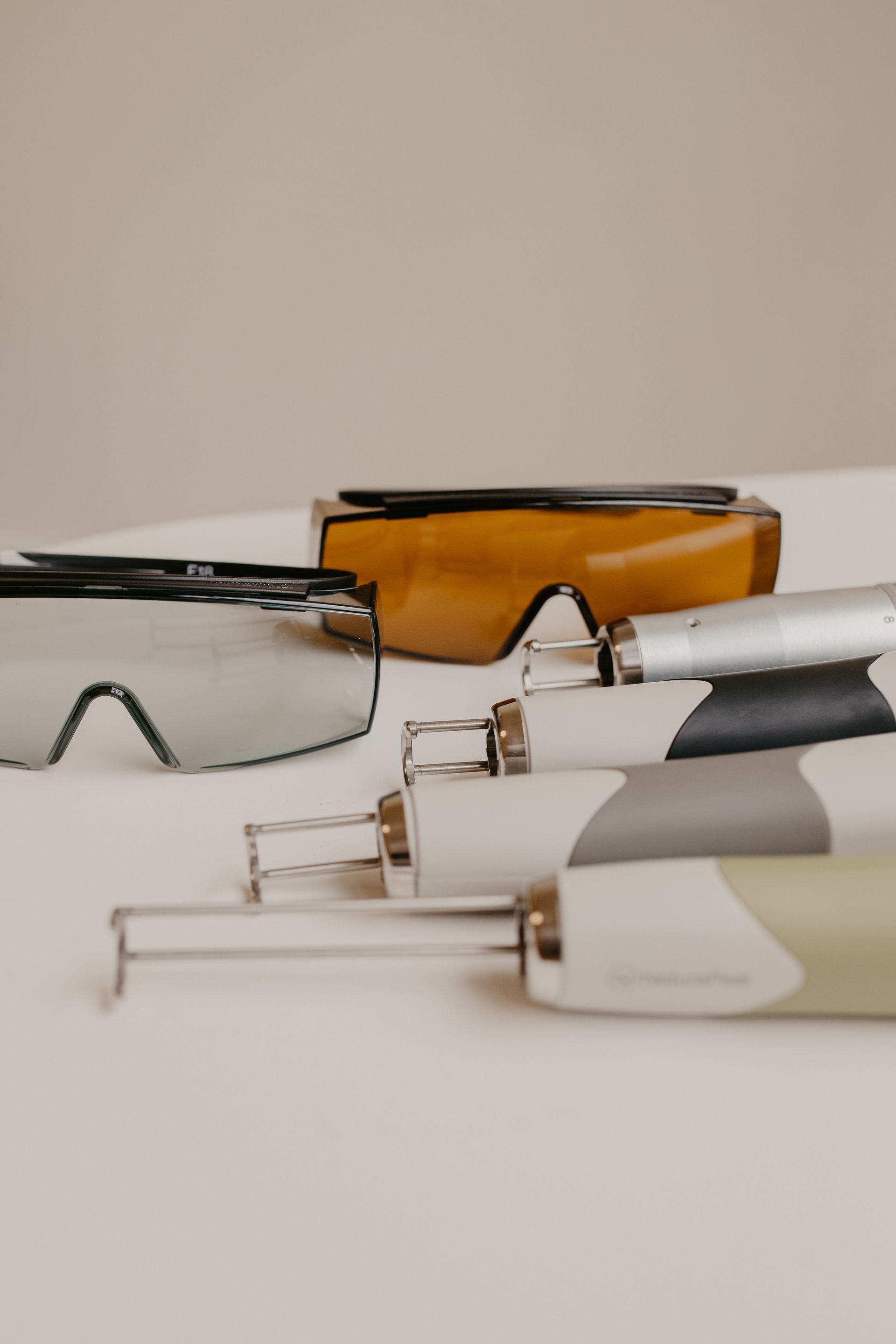 Woman with closed eyes, receiving cosmetic treatment with a device.