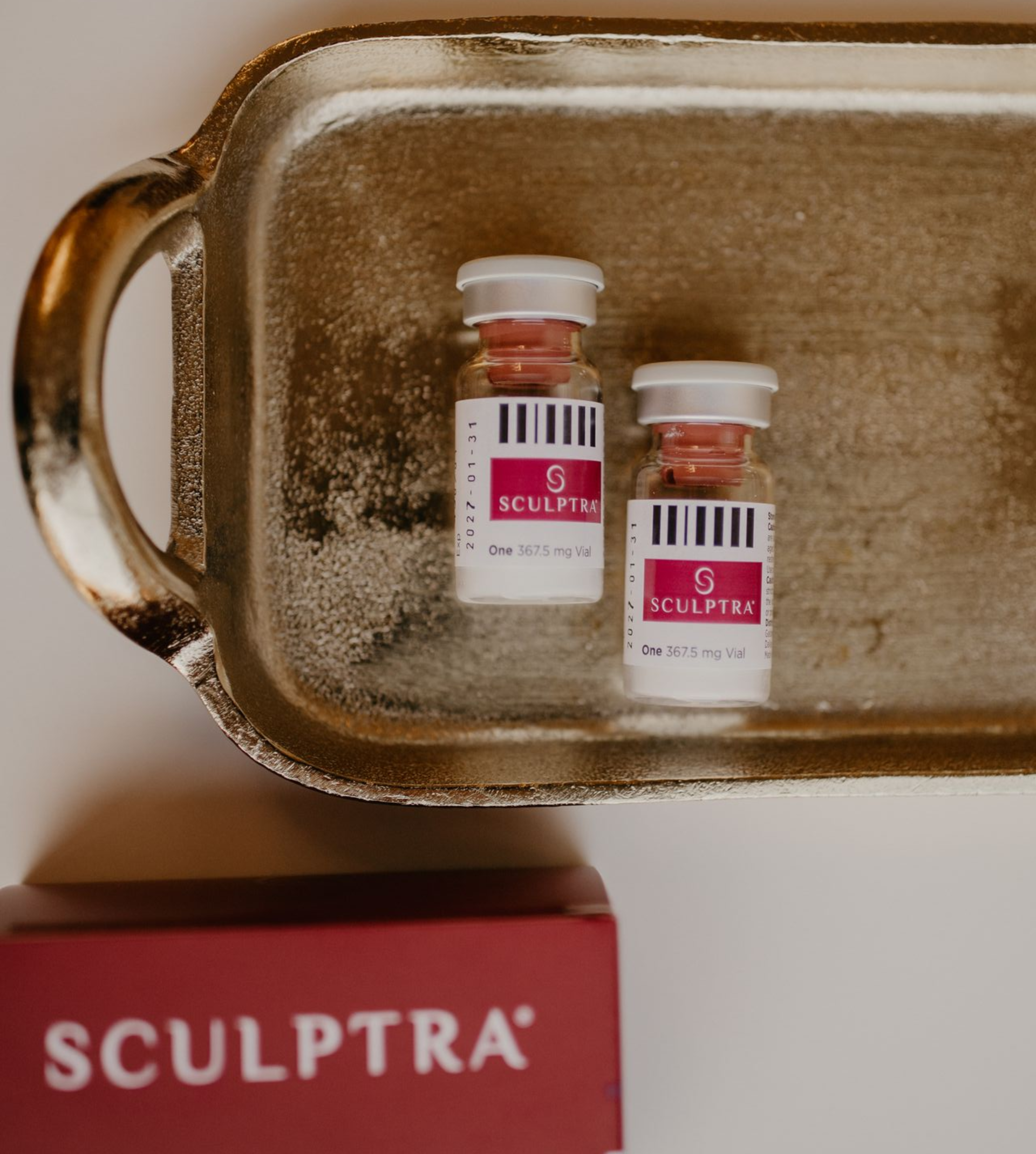 A woman with a towel wrapped around her head is smiling.