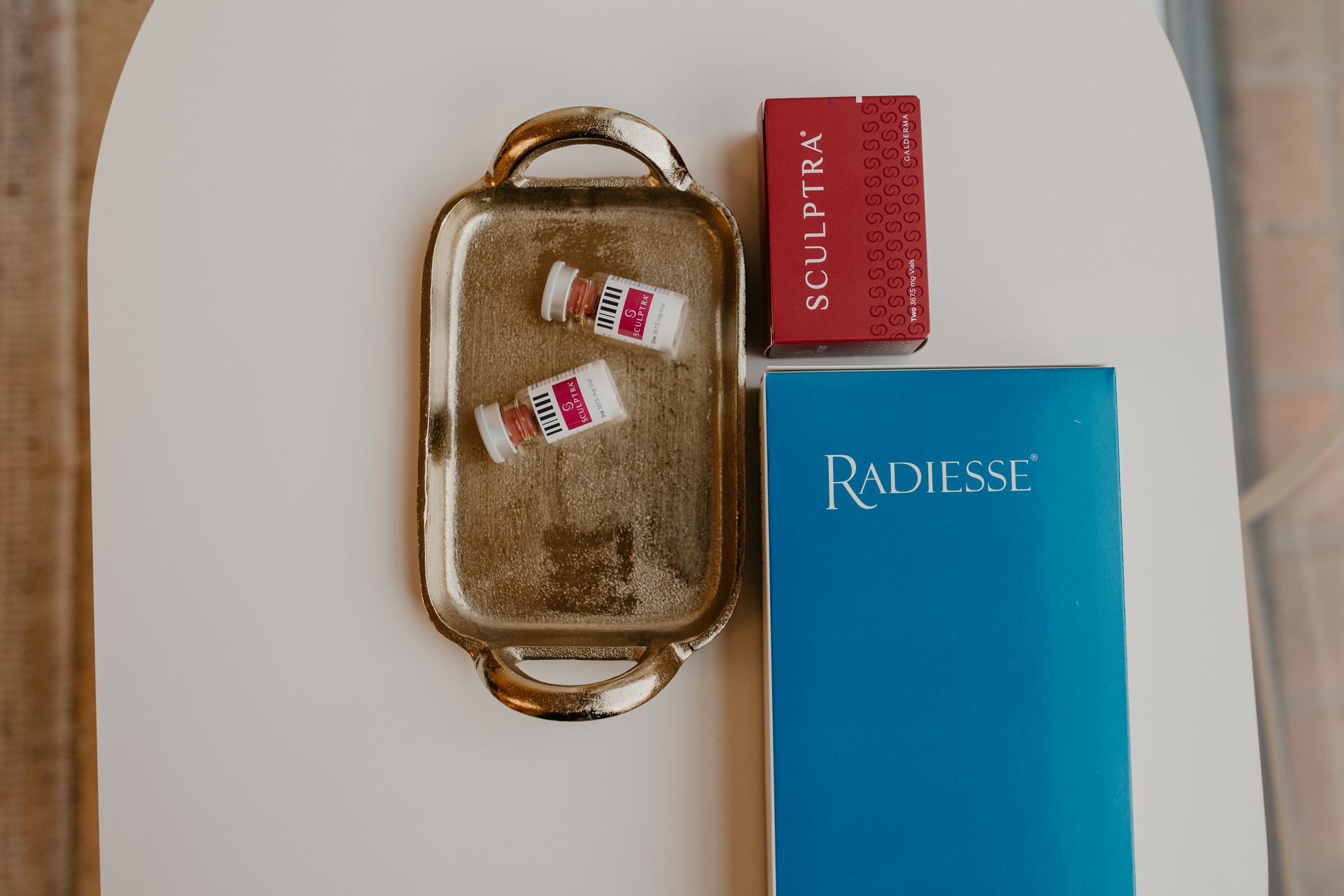 A woman is standing in front of a plant with green leaves.