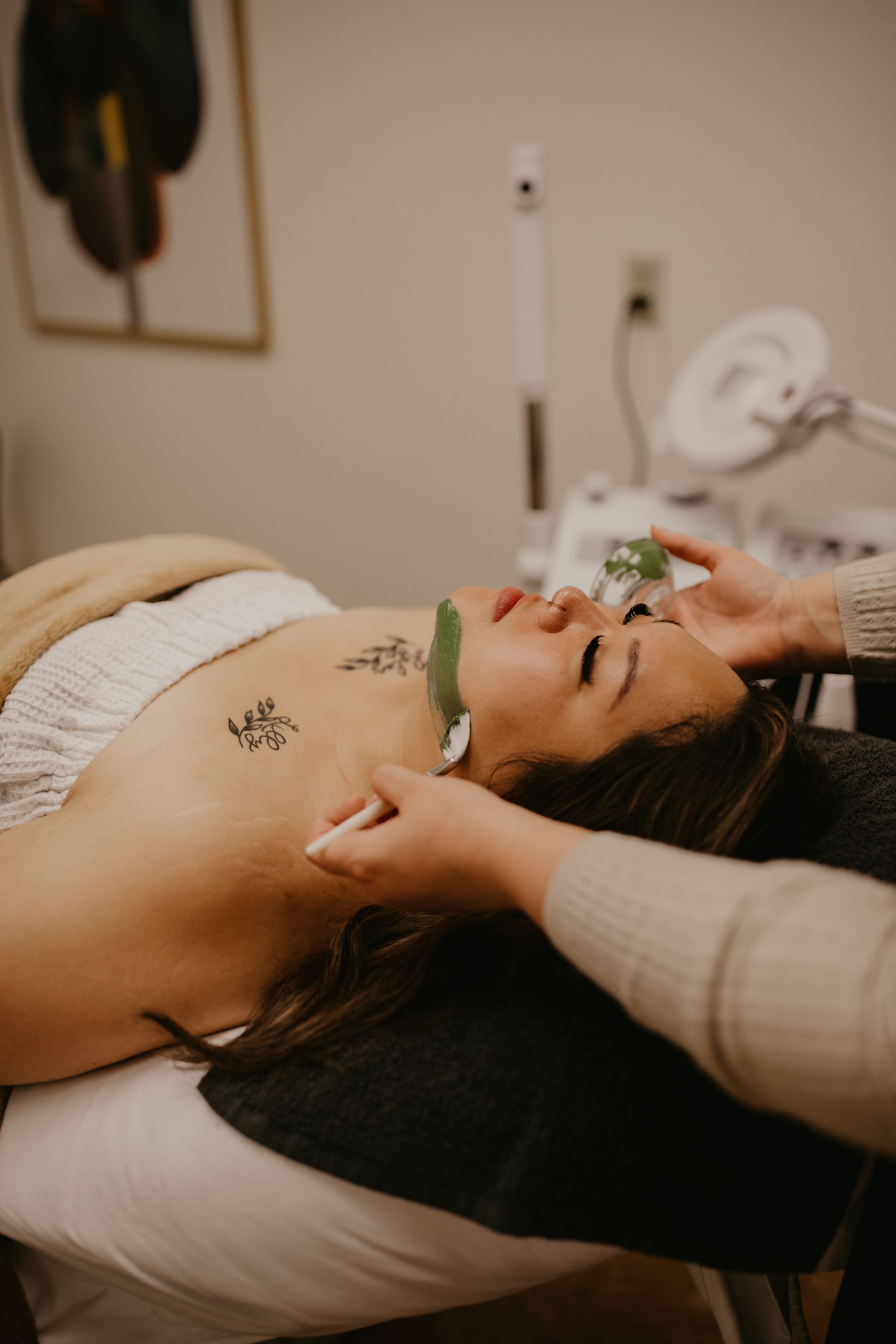 A woman with a towel wrapped around her head is smiling.