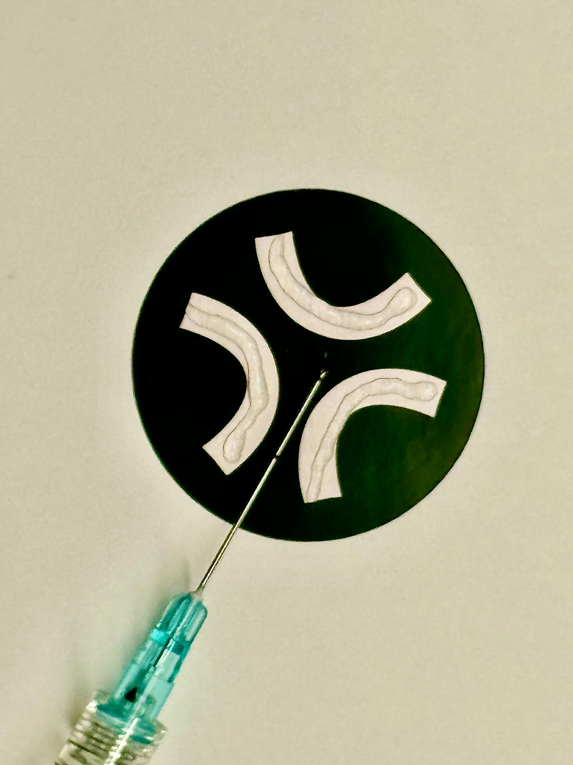A blue syringe with a needle sticking out of it