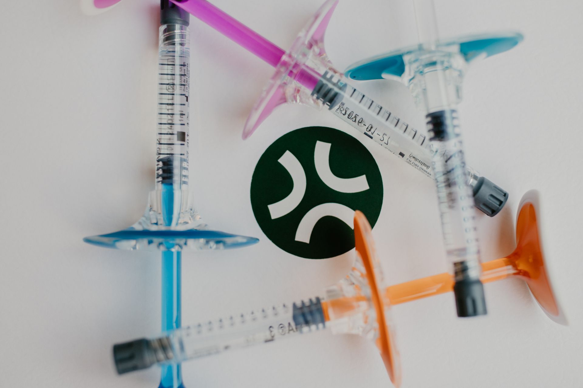 A woman is getting a botox injection in her face.