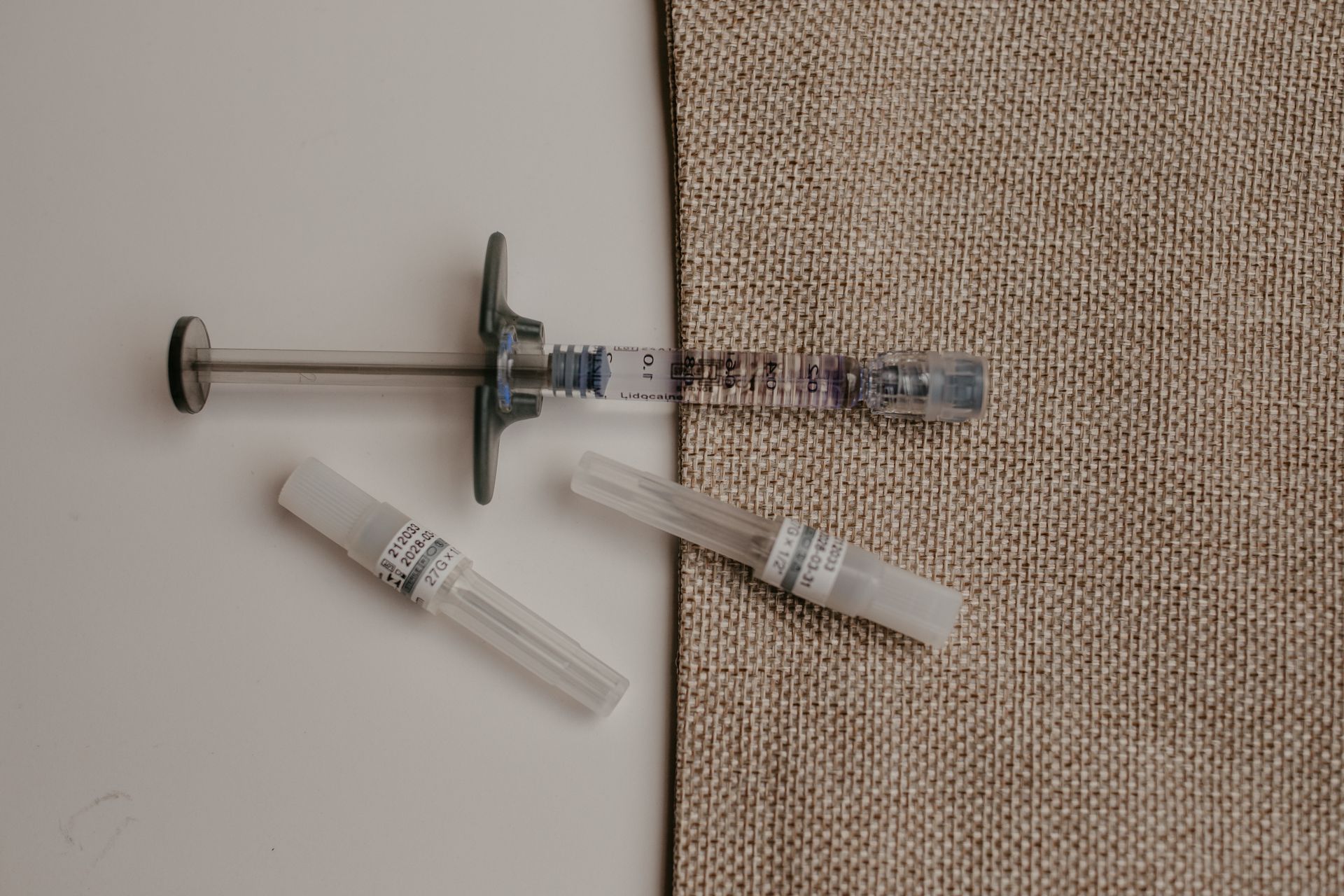 A woman with long curly hair is smiling and looking at the camera.
