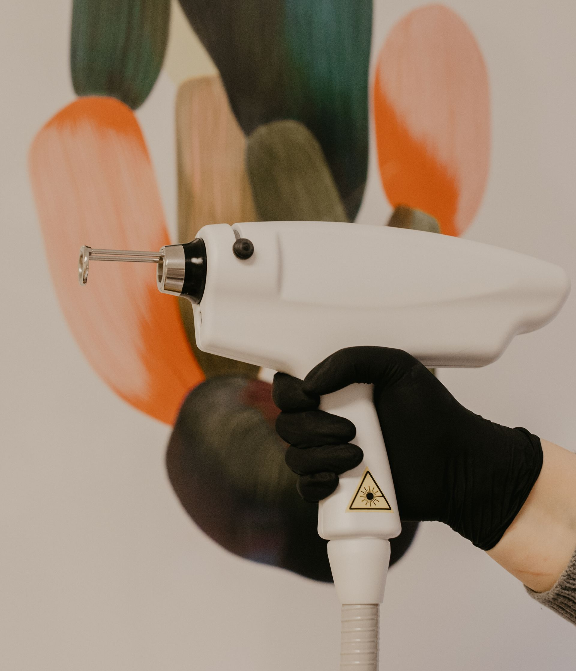 Woman with reddish skin on her face, looking in mirror, touching her cheek.