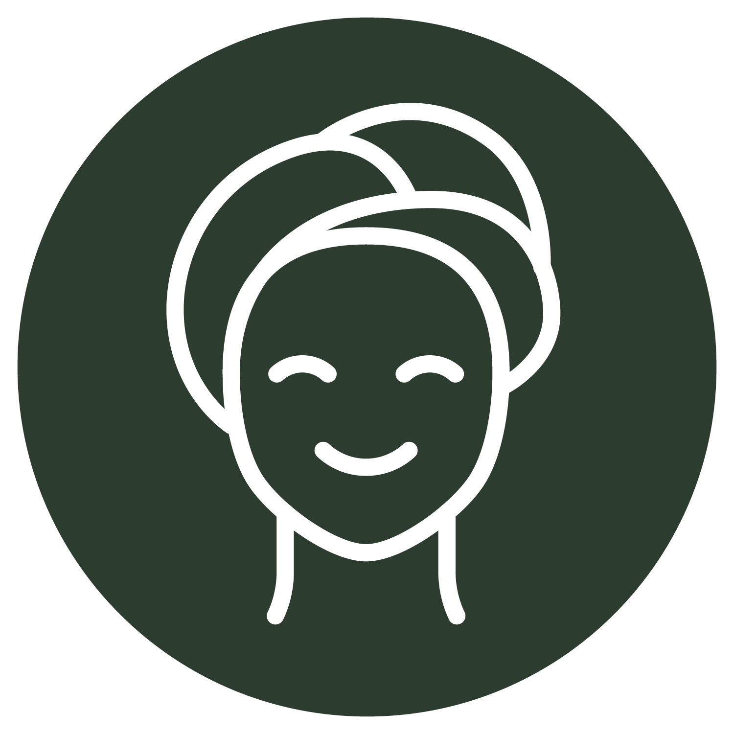 A woman with a towel wrapped around her head is smiling.