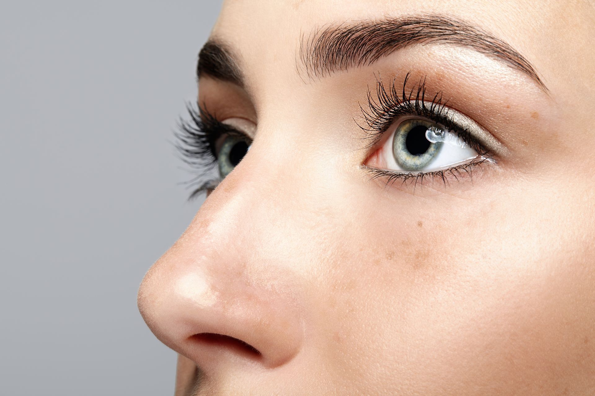 A close up of a woman 's nose and eye.