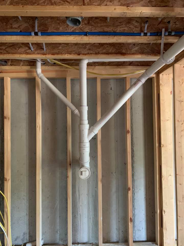 A room with a lot of pipes hanging from the ceiling.