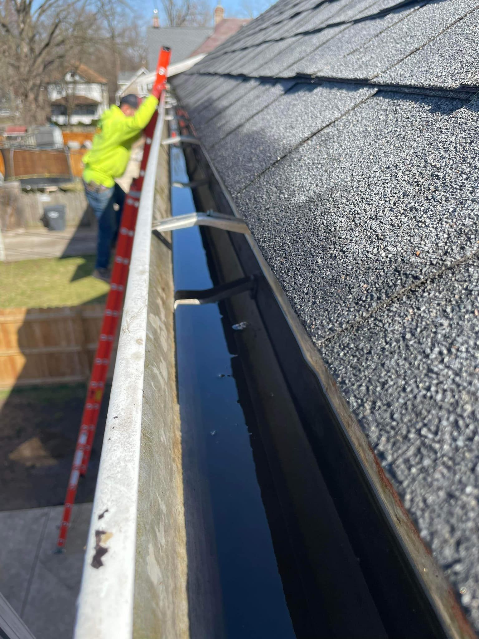 A large house with a lot of windows and a garage on a rainy day.