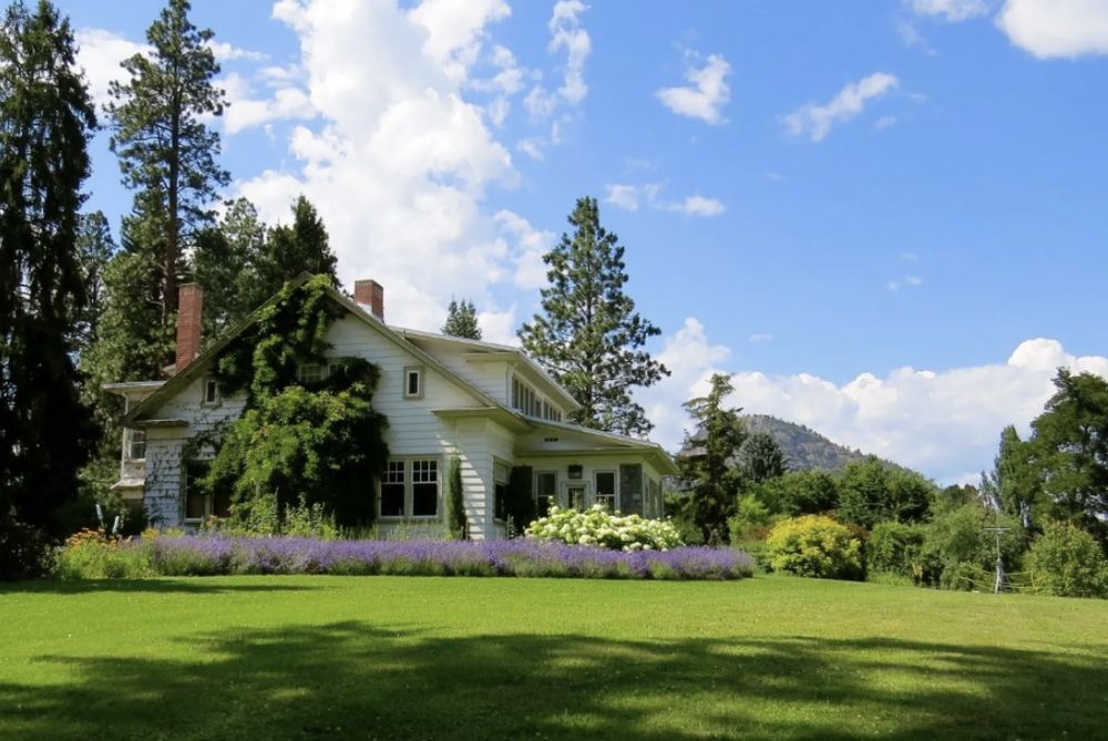 A large house with a lot of windows and a garage on a rainy day.