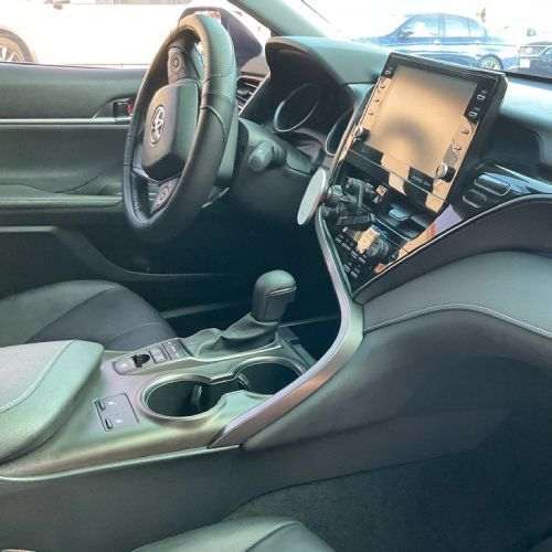 The interior of a toyota camry with a steering wheel and dashboard