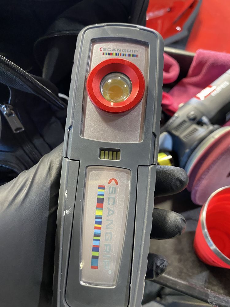 A person is holding a scanner in their hand