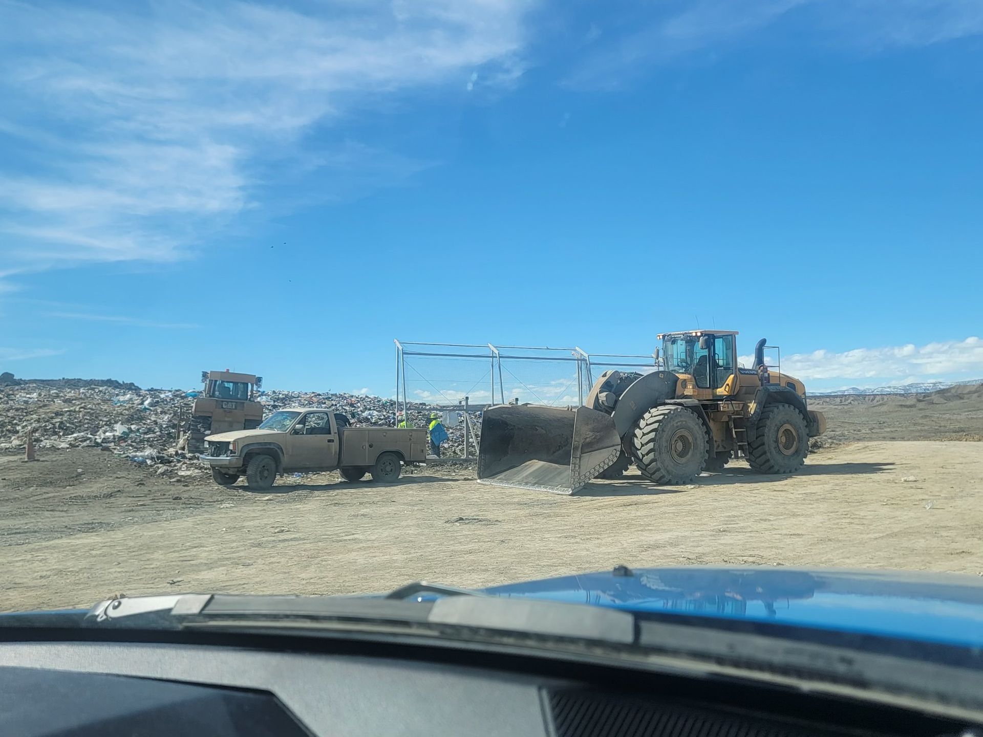 tractor and truck at a silage pile