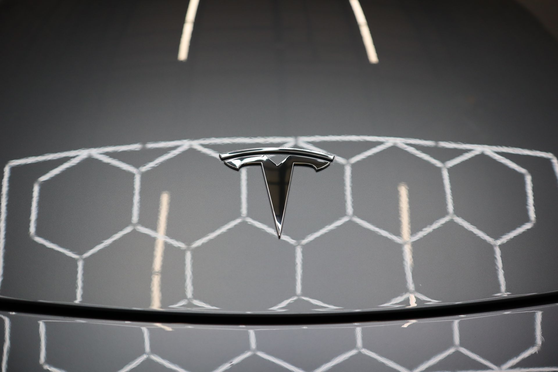 A close up of a tesla logo on a table