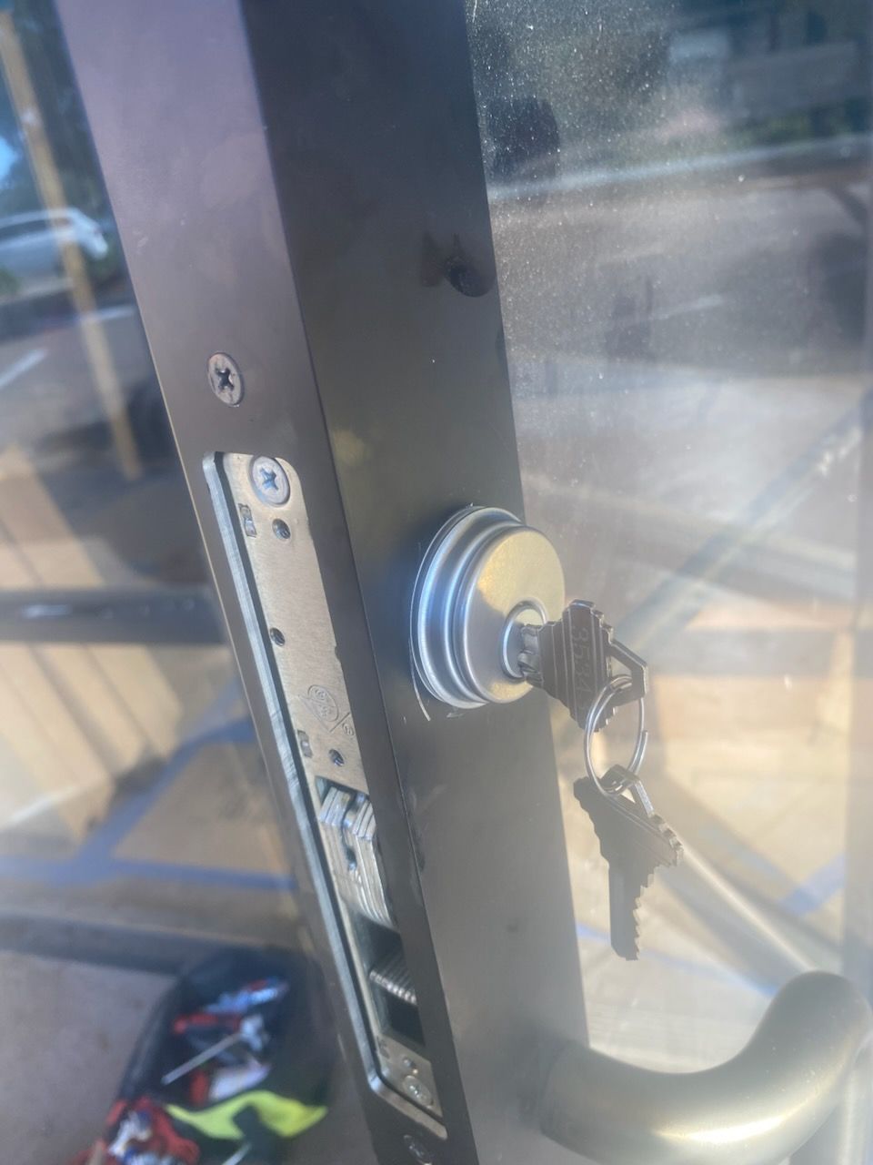 A close up of a door lock with keys in it