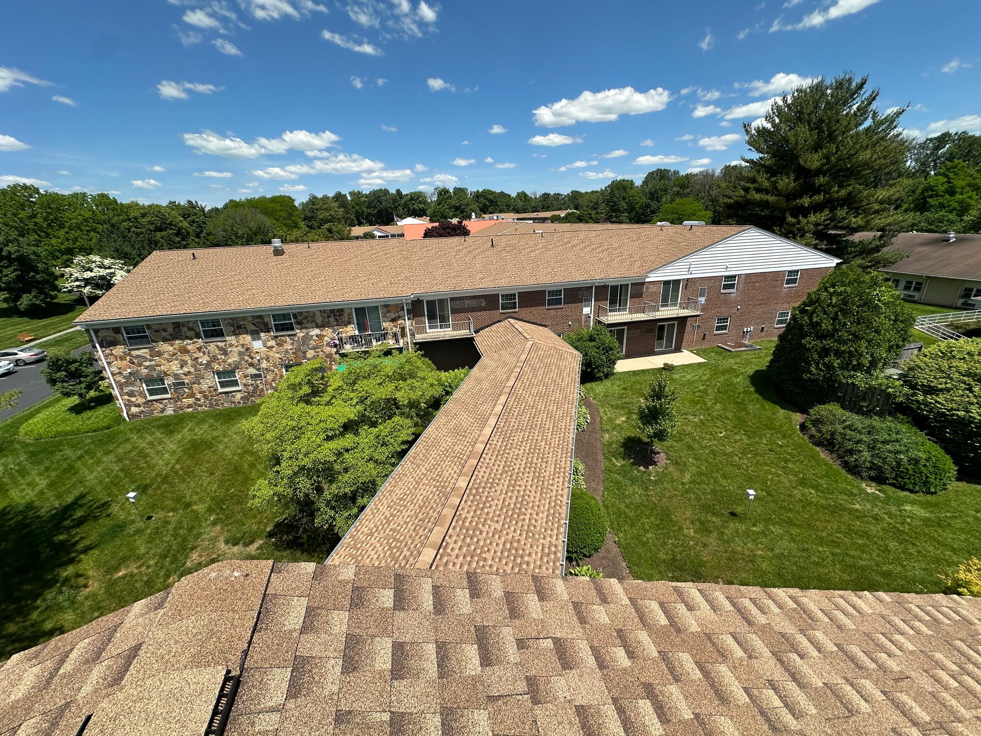 An aerial view of a building with a roof that is covered in shingles.