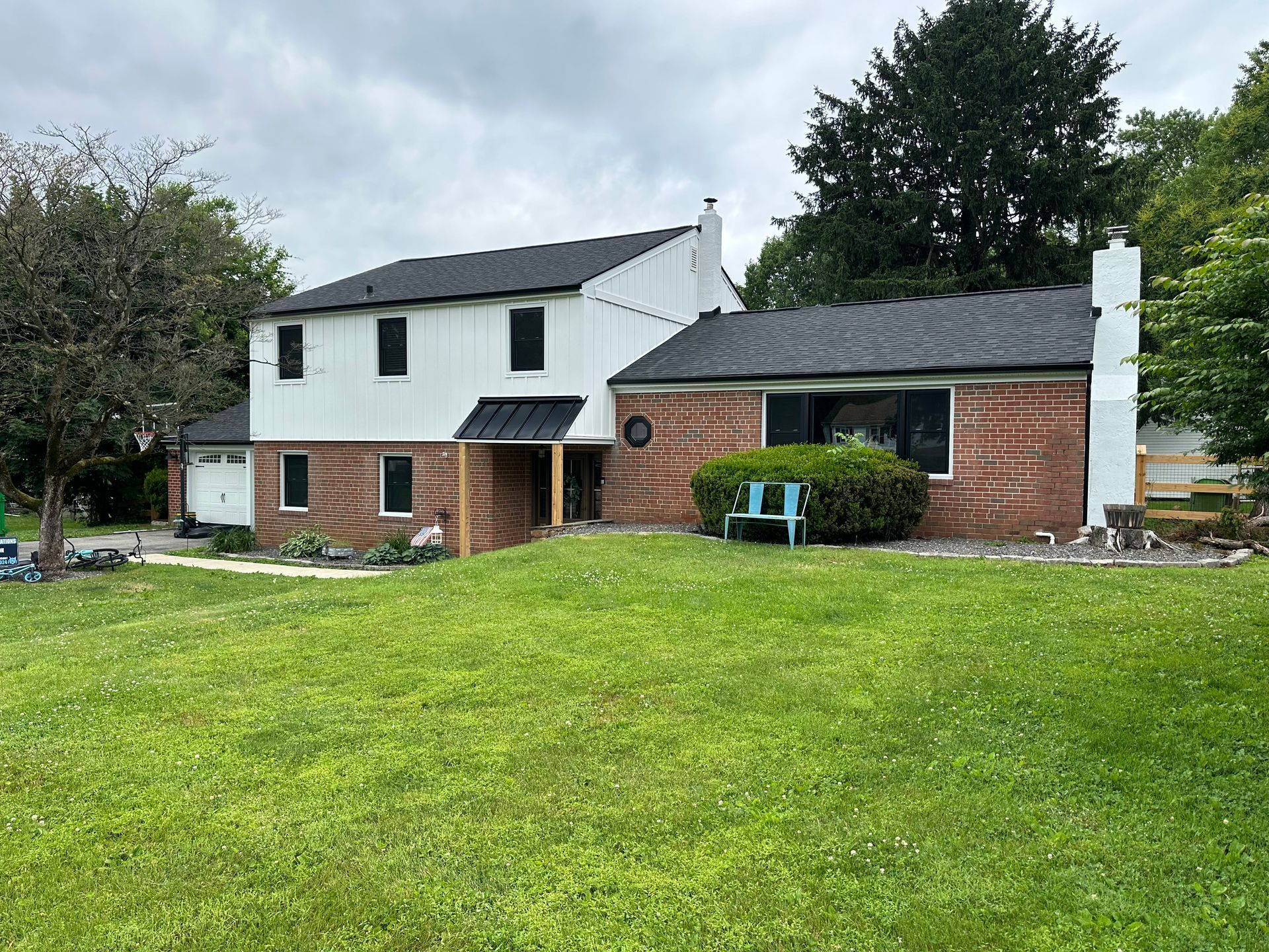 A large house with a large lawn in front of it.