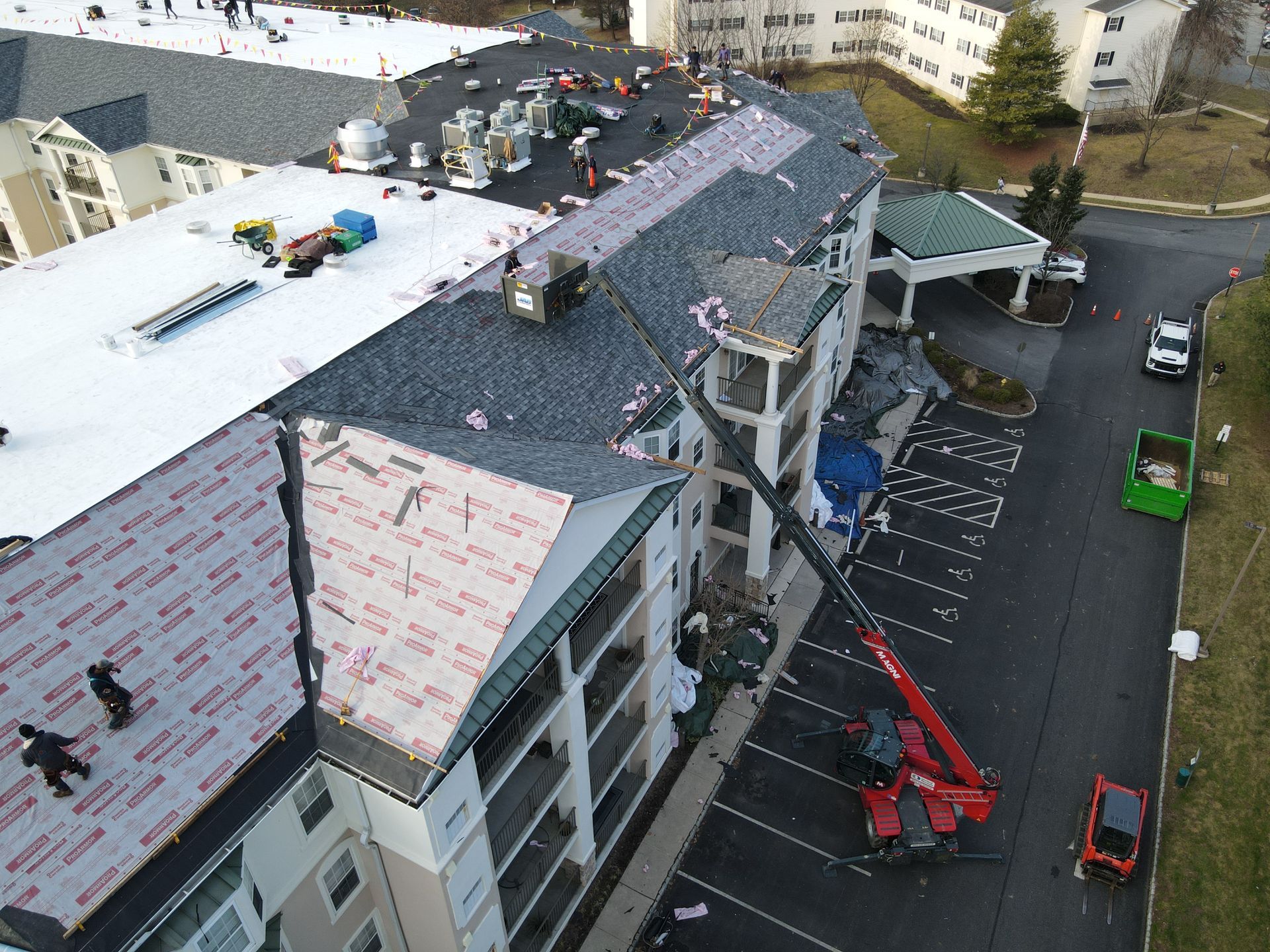 An aerial view of a roof being installed on a building.