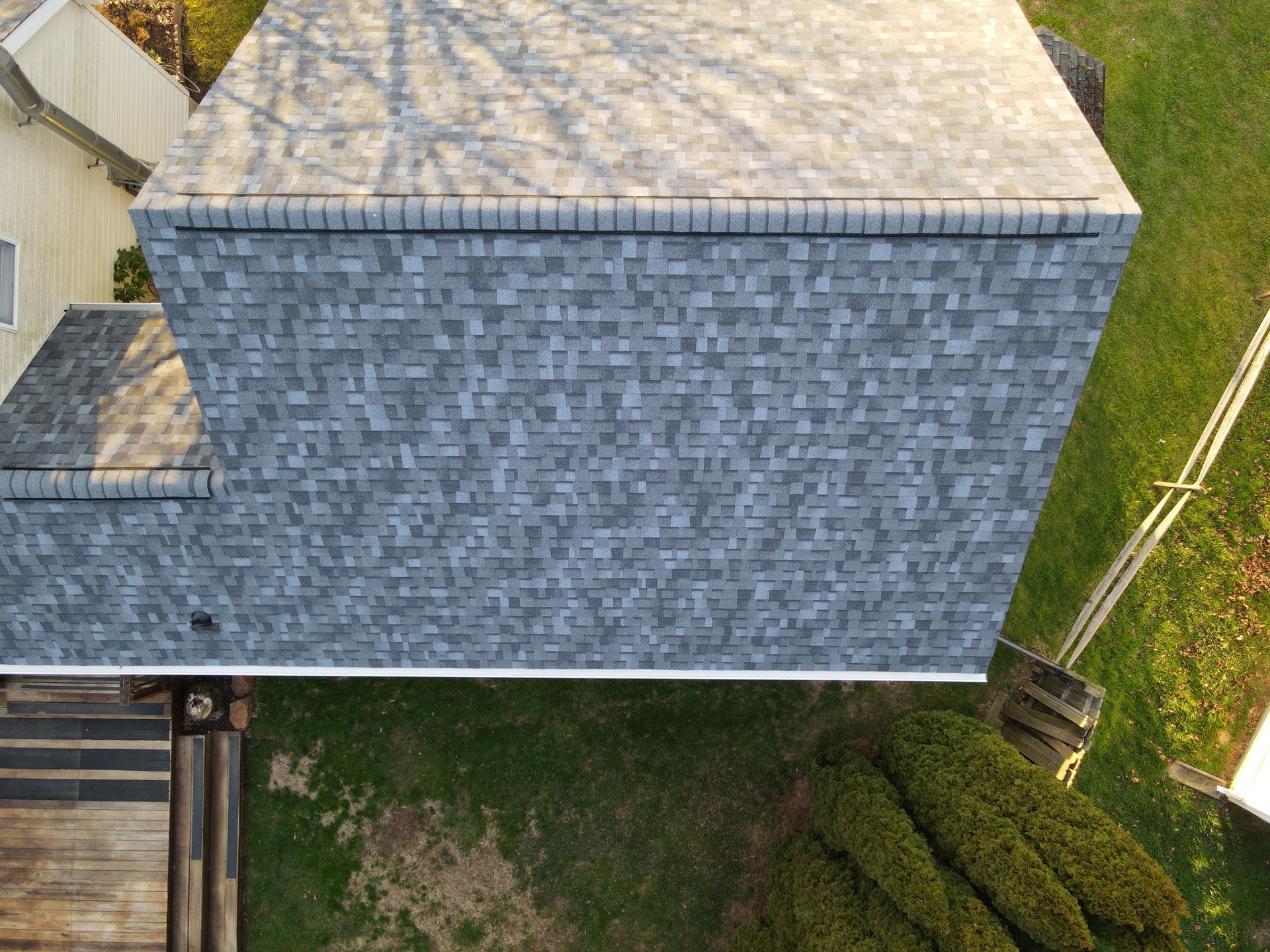 An aerial view of a house with a roof and a deck.