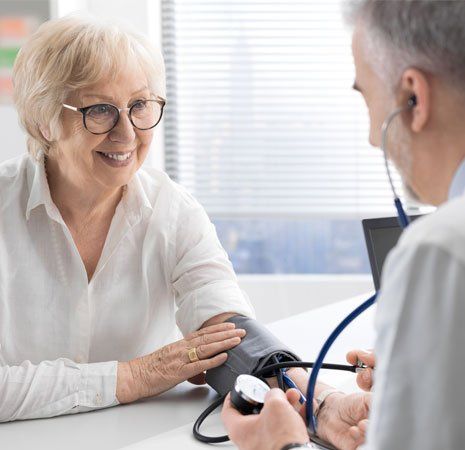Doctor Checking the Patient's Blood Pressure — Greenwood, SC — Physicians Care
