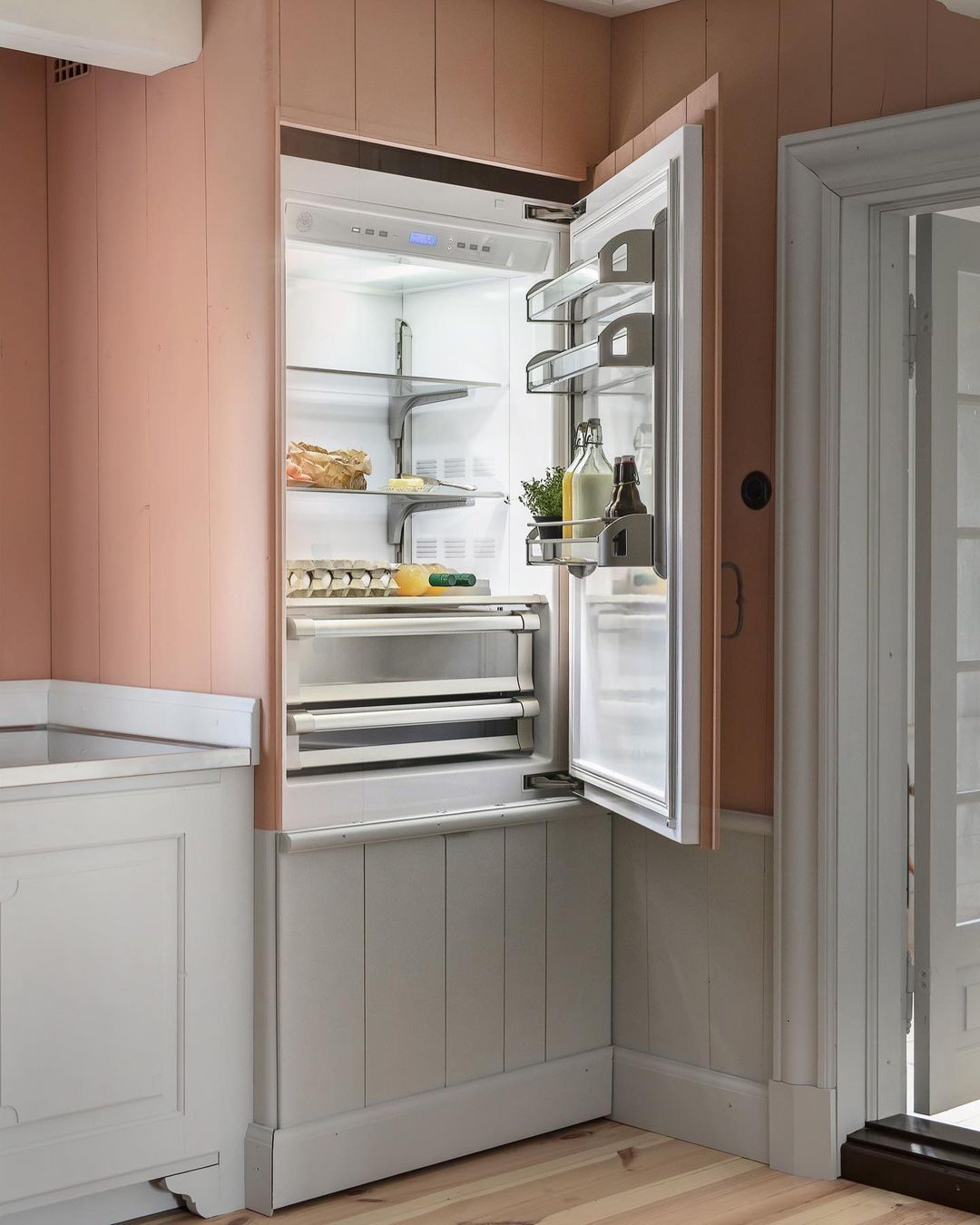 Uma geladeira em uma cozinha com a porta aberta.