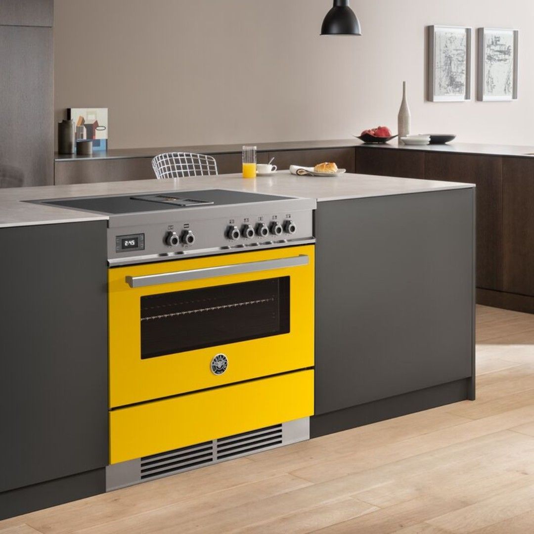 Uma cozinha com fogão amarelo e armários pretos