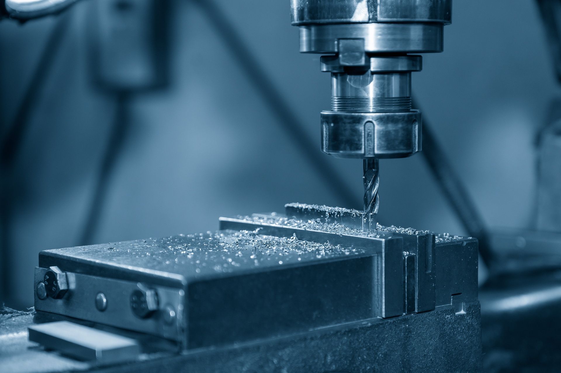 A machine is cutting a piece of metal in a factory.
