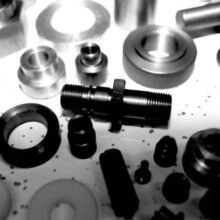 A black and white photo of a bunch of metal parts on a table.