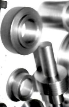 A bunch of metal objects are stacked on top of each other on a white surface.