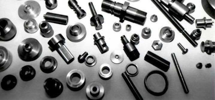 A bunch of nuts and bolts on a white surface