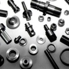 A black and white photo of a bunch of metal parts on a table.