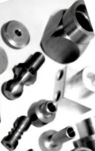 A bunch of metal parts are laying on a white surface