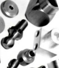 A black and white photo of a bunch of metal parts on a table.