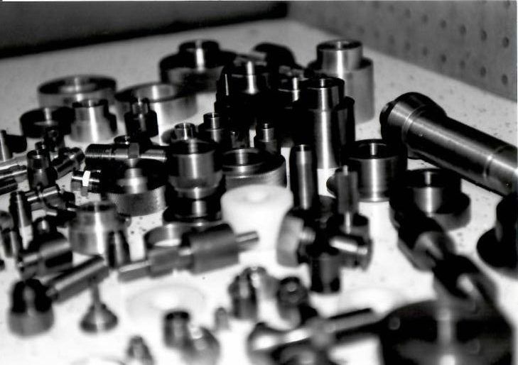 A black and white photo of a bunch of metal parts on a table