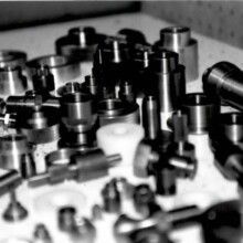 A black and white photo of a bunch of metal parts on a table.