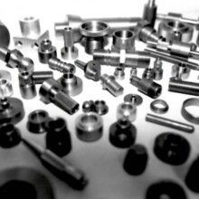 A black and white photo of a bunch of metal parts on a table.