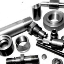 A bunch of metal parts are sitting on top of each other on a table.