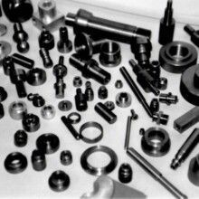 A black and white photo of a bunch of metal parts on a table.