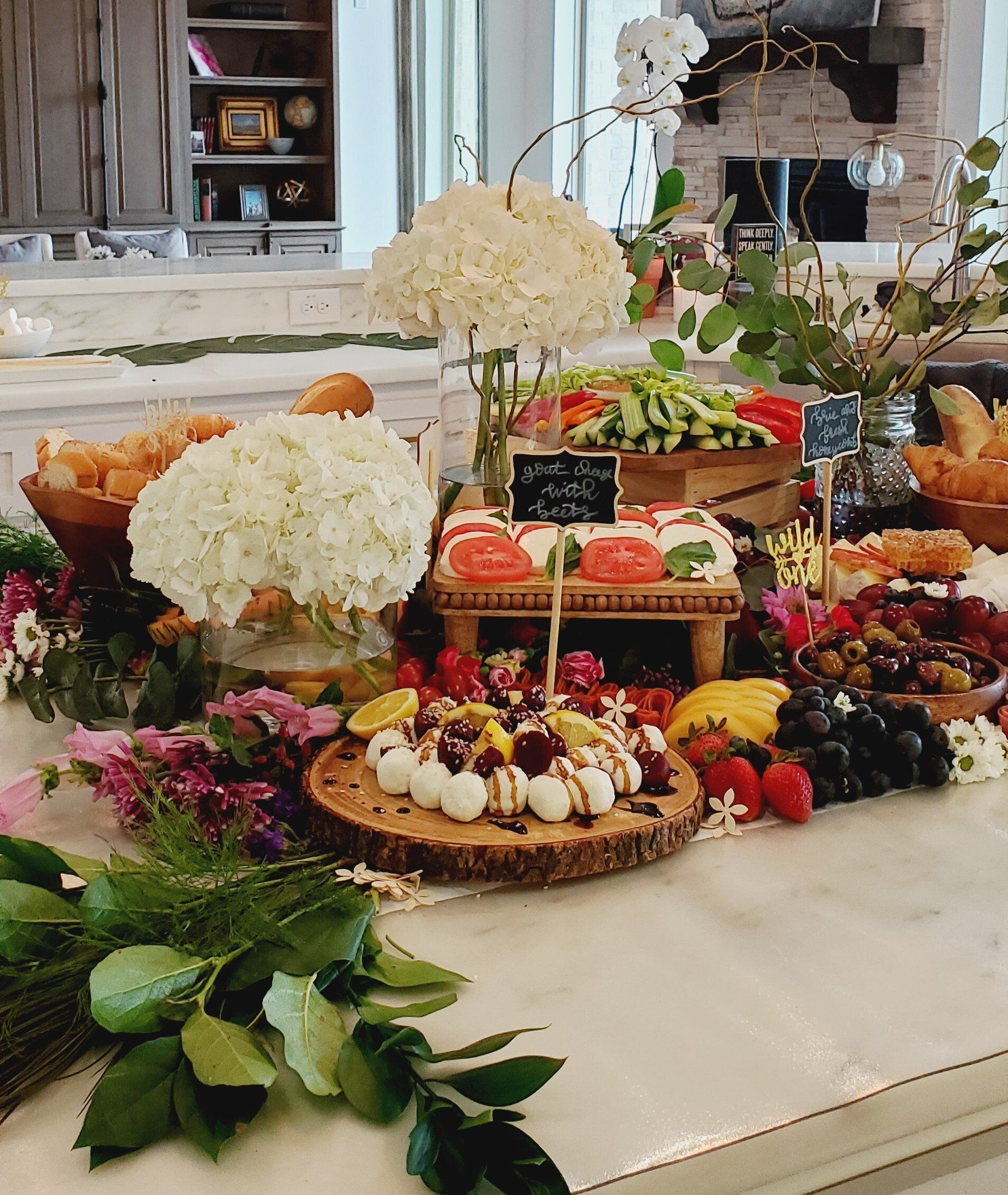 A table with a variety of food and flowers on it