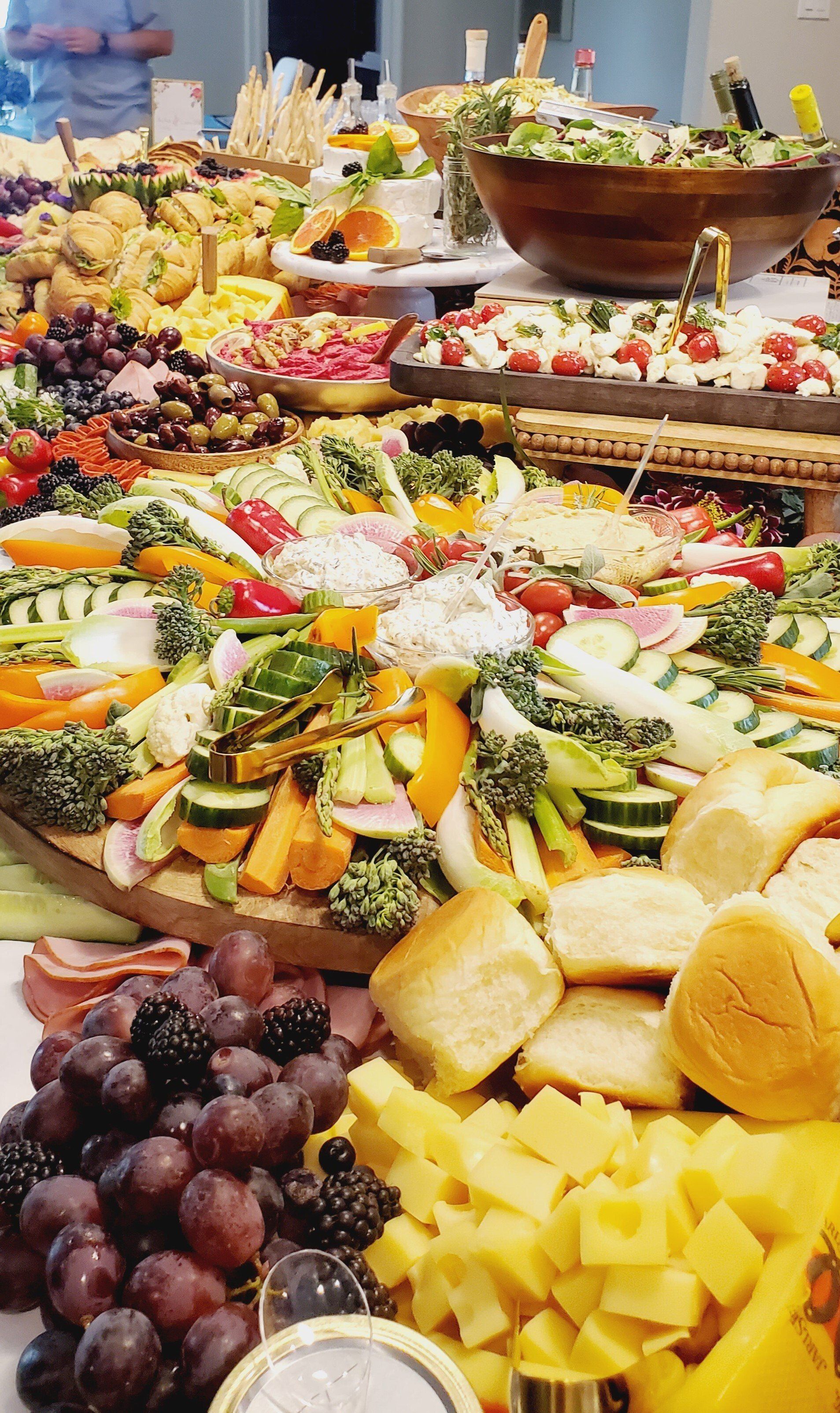 A buffet table filled with lots of fruits and vegetables.