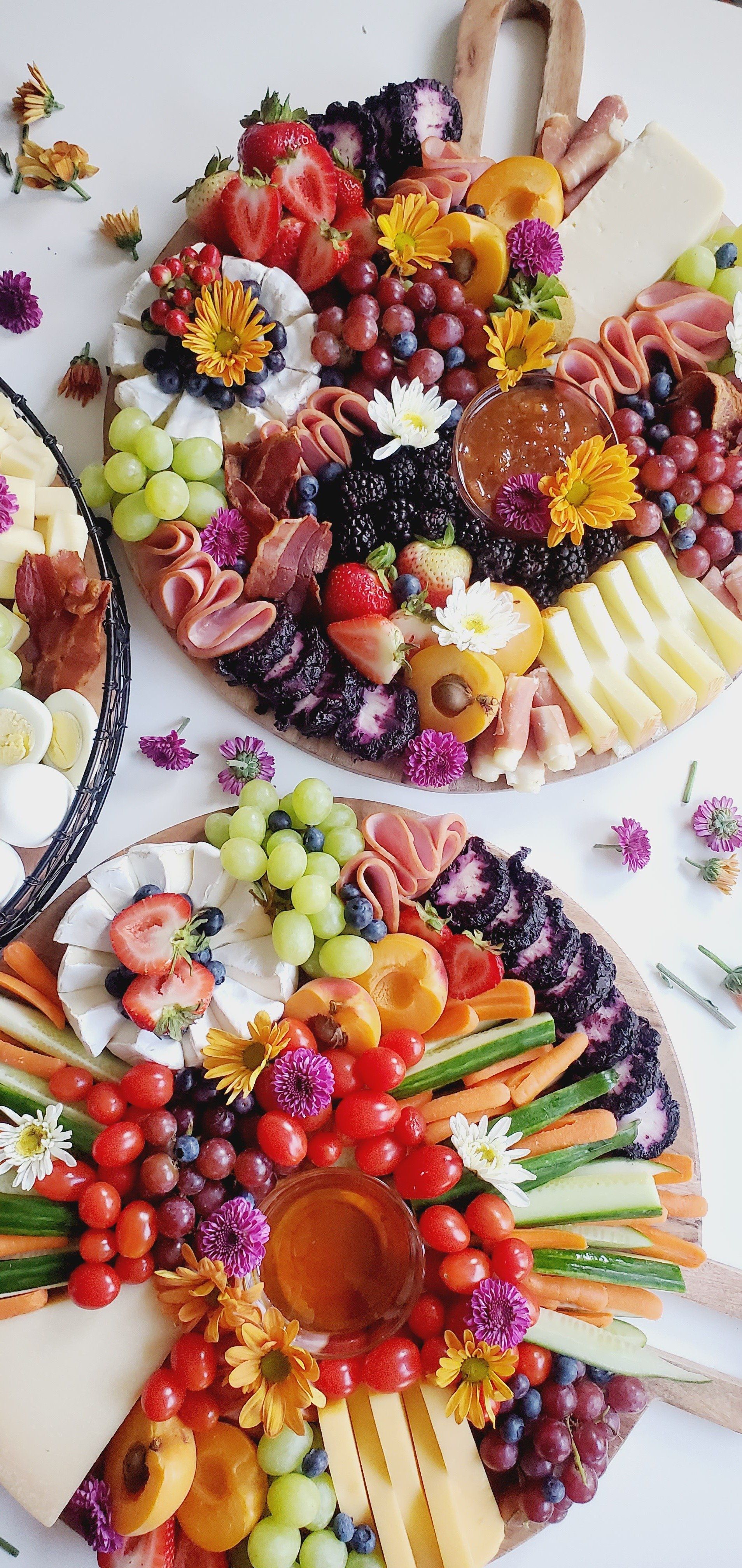 There are many different types of fruits and vegetables on the plates.