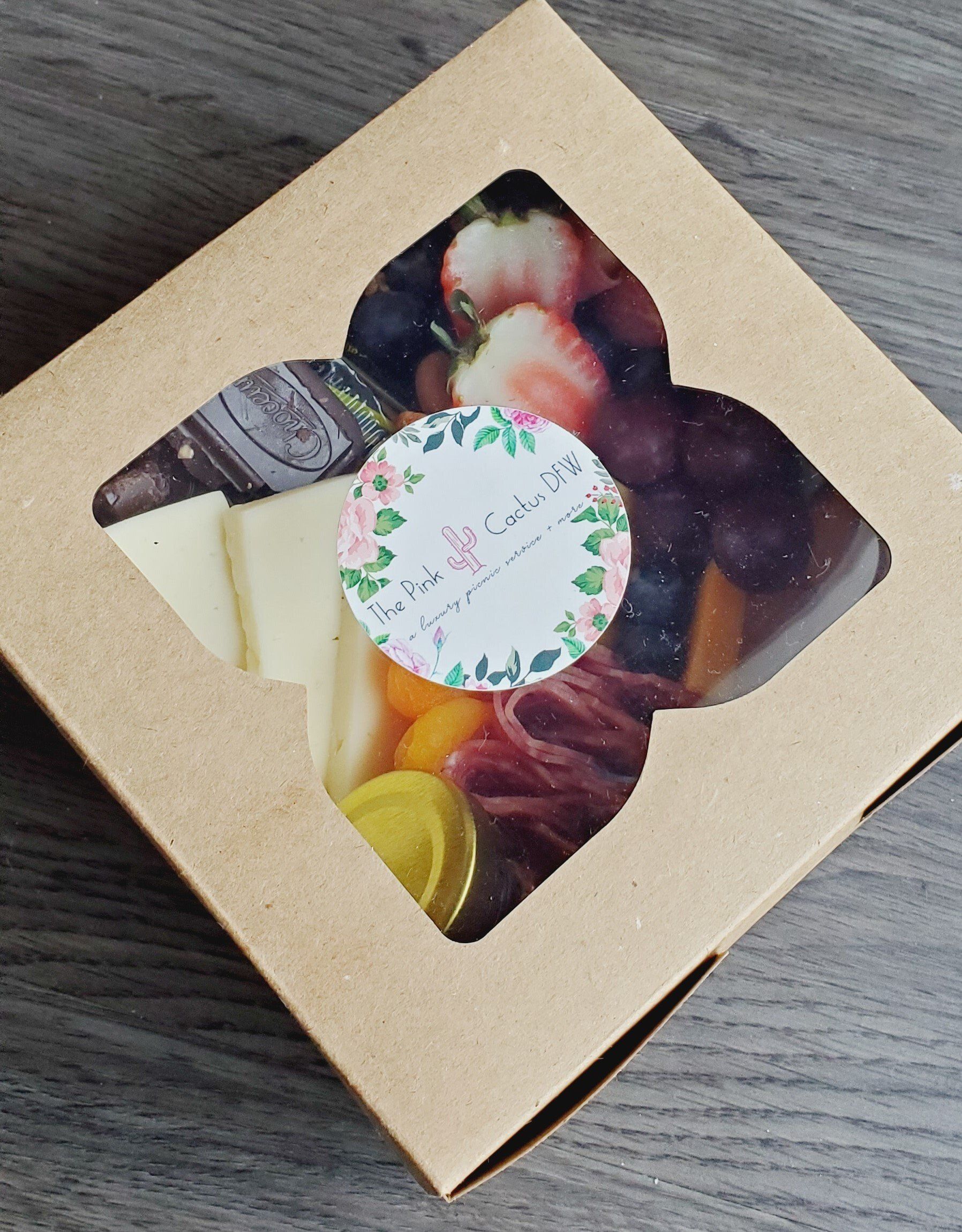 A box of food with a sticker that says ' strawberry ' on it