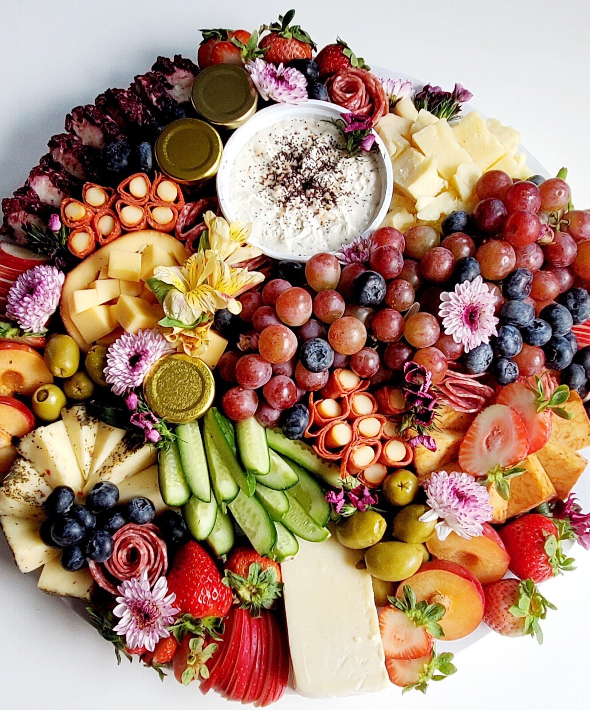 A large platter filled with fruits and vegetables on a table.