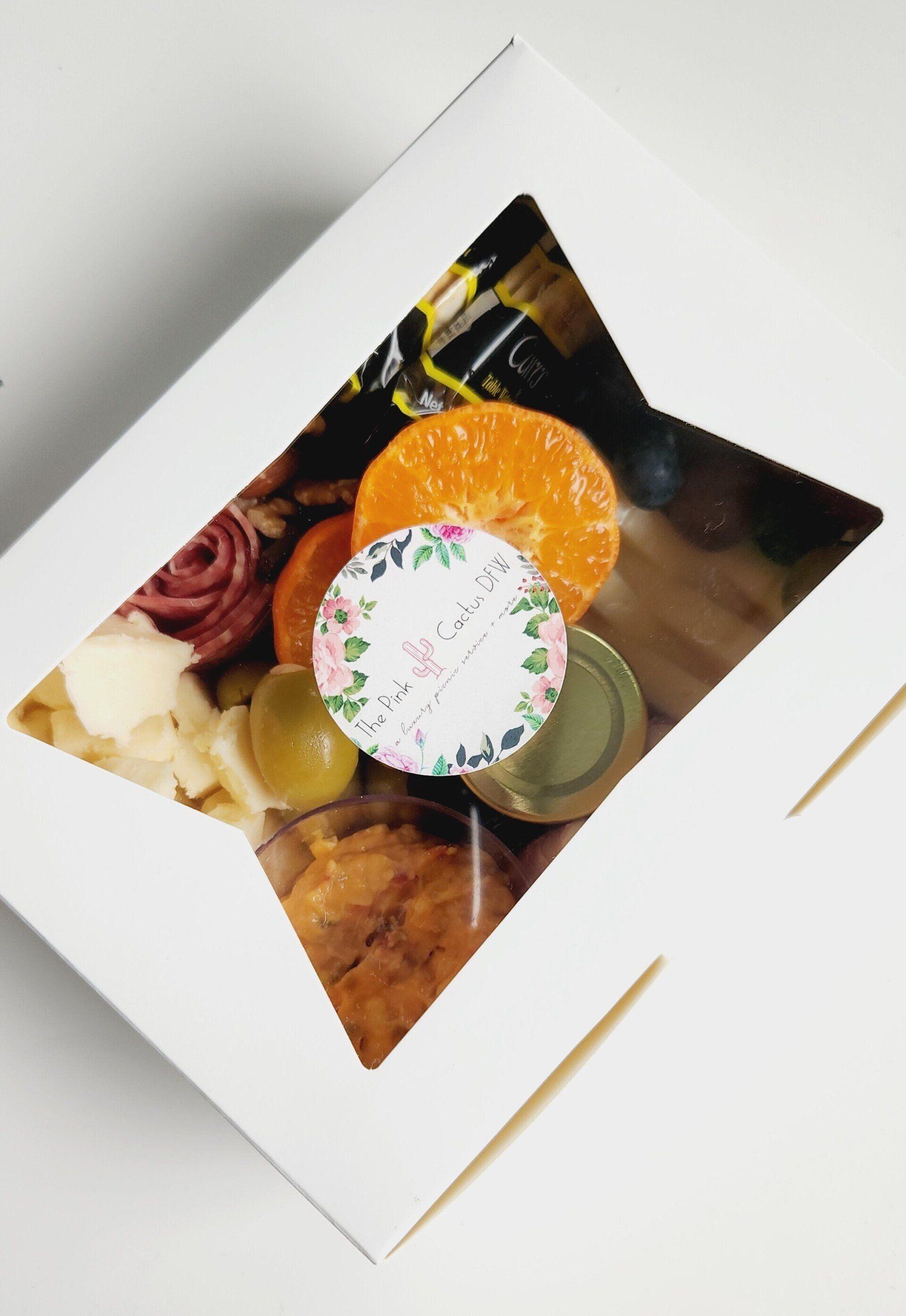 A white box filled with food and a sticker that says ' i love you ' on it